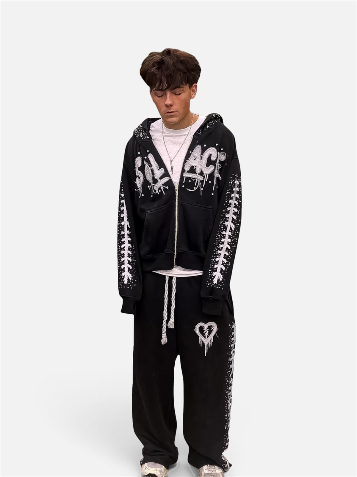 Black Solace zip-up and sweats set worn by a model, front view